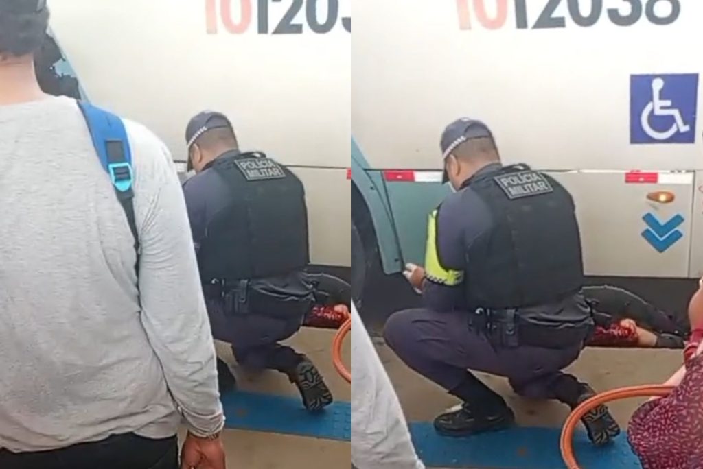 Policial presta primeiros socorros a mulher com perna ferida após acidente com ônibus no Terminal 1 de Manaus