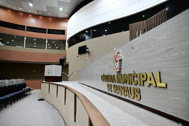 Fachada da Câmara Municipal de Manaus com movimentação de pessoas após evacuação por alerta de fumaça.