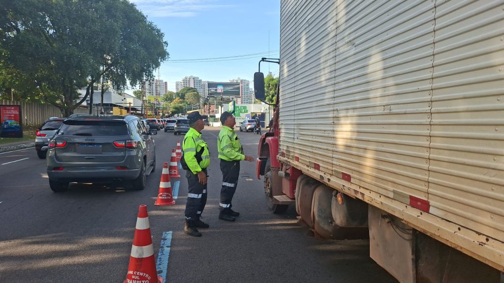 Agentes do IMMU fiscalizando caminhões e veículos de carga na Avenida Mário Ypiranga Monteiro em Manaus para garantir fluidez no trânsito.