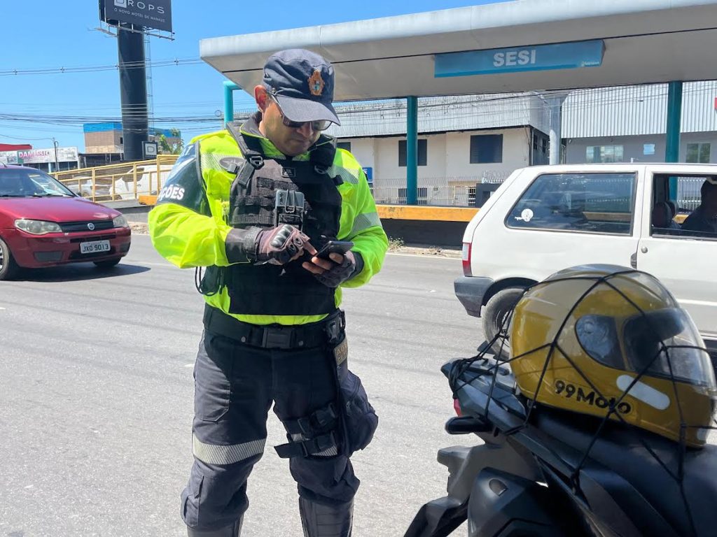 Agentes do IMMU realizando fiscalização de trânsito em via pública de Manaus para combater estacionamento irregular.
