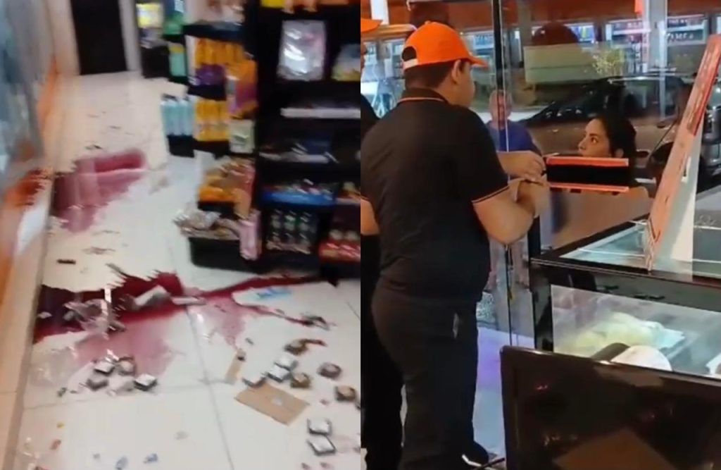 Mulher alterada na porta de uma loja de conveniência no Parque 10 em Manaus enquanto funcionários tentam conter a situação.