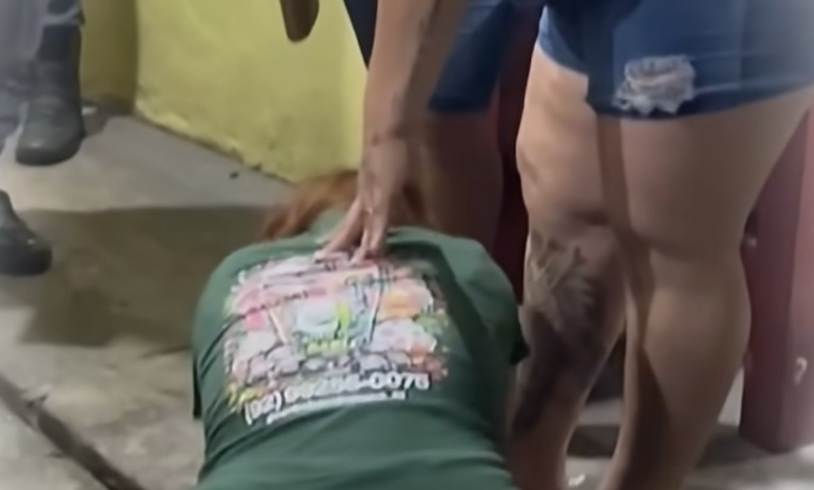 Mulher se desespera sobre corpo de jovem assassinado a tiros no bairro Compensa em Manaus.