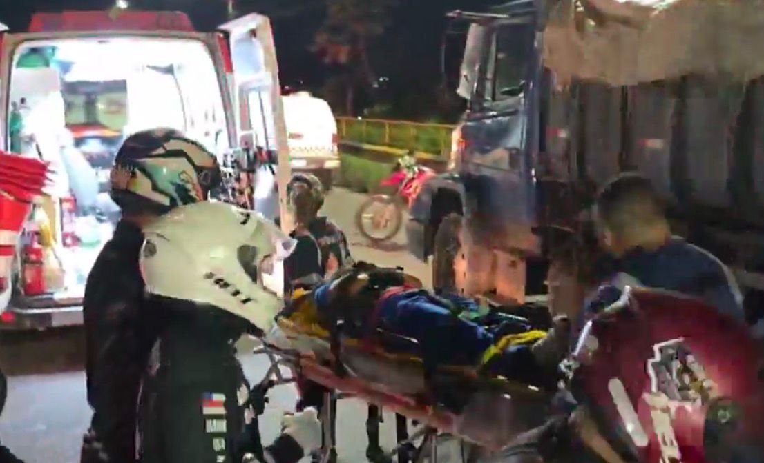 Motocicleta caída no chão após colidir com uma caçamba estacionada em uma rua de Manaus