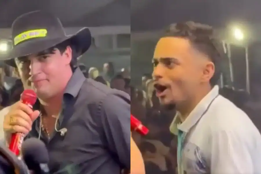fã contido no palco durante show do cantor natanzinho lima