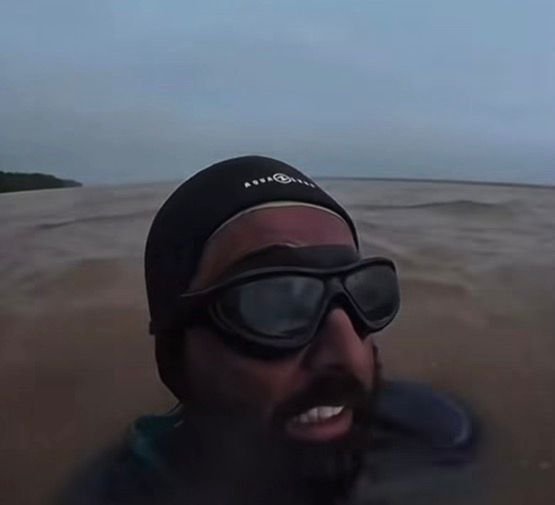 Triatleta colombiano Wilber Honório nadando no Rio Amazonas durante expedição ambiental.
