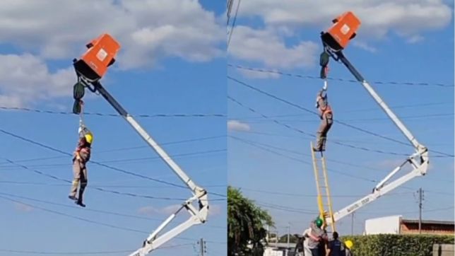 eletricista suspenso por cinto de segurança durante manutenção